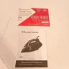A Russell Hobbs iron and a promotional voucher are shown on a white surface. Podgląd zdjęcia produktu