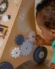 A baby playing with a wooden activity walker. Produktbild-Vorschau