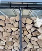A close-up view of a transparent PVC cover with a zipper, protecting a stack of firewood. Produktbild-Vorschau