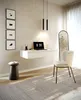 A modern home office setup with a floating desk, chair, and decorative elements. Produktbild-Vorschau
