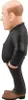 A side view of a figurine of a bald man wearing a black suit and brown shoes. Podgląd zdjęcia produktu