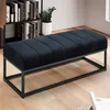A black velvet bench with a metal frame is placed in a room with a bookshelf and a plant. Podgląd zdjęcia produktu