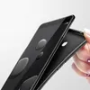 A hand holding a black phone case behind a black smartphone. Produktbild-Vorschau