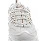 A close-up view of the front of a white Skechers D-Lites sneaker with rose gold accents. Voir les images du produit