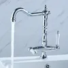 A chrome faucet with white handles is shown in a bathroom or kitchen setting, with water running from the spout. Podgląd zdjęcia produktu