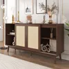 A dark wood sideboard with rattan woven doors and wooden legs, decorated with various items on top and inside. Produktbild-Vorschau
