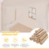 Close-up view of a children's play tent with text and icons highlighting its features, and a pile of wooden rods in the foreground. Produktbild-Vorschau