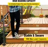 A person is walking down a wooden deck staircase, holding onto a metal handrail. There are chairs and potted plants on the deck. Anteprima dell’immagine prodotto