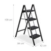 A black four-step folding ladder is shown against a white background with dimensions indicated. Produktbild-Vorschau