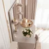 A vanity table with makeup and flowers, next to a window with curtains. Produktbild-Vorschau