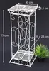 A white metal plant stand with decorative scrollwork is shown against a black background, with dimensions indicated by text overlays. Anteprima dell’immagine prodotto