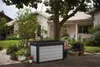 A storage box is placed in a garden setting in front of a house. Podgląd zdjęcia produktu