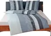 A bed with bedding set, pillows, and a headboard.