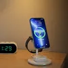 A wireless charging stand with a phone, smartwatch, and earbuds on a wooden surface. Produktbild-Vorschau