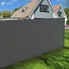 A grey privacy screen is installed along a fence in a backyard, with a house in the background. Produktbild-Vorschau