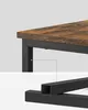 Close-up of a wooden table top and its black metal frame. Náhled obrázku produktu