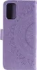 A close-up view of a purple flip phone case with a mandala design embossed on it. Produktbild-Vorschau