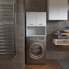 A laundry room with a washing machine and cabinets. Produktbild-Vorschau