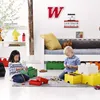 Two children are playing with LEGO storage boxes in a room. Anteprima dell’immagine prodotto