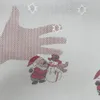 A close-up of a Christmas-themed fabric with a large hand shape and cartoon characters of Santa Claus and a snowman. Produktbild-Vorschau