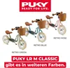 Three Puky balance bikes in different retro colors (green, blue, pink) with wicker baskets are displayed against a white background. Text overlays indicate the brand, product name, and available colors. Produktbild-Vorschau