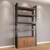 A tall, narrow industrial-style shelving unit with a wooden cabinet base. Produktbild-Vorschau