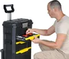 A man is kneeling and sorting through the contents of a rolling toolbox. Náhľad obrázku produktu