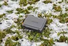 A gray Gardena winter protection box sits on grass with patches of snow. Produktbild-Vorschau