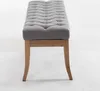 A gray upholstered bench with wooden legs is shown against a white background. Náhled obrázku produktu