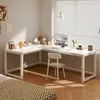 A modern white L-shaped computer desk with a chair and computer setup in a well-lit room. Produktbild-Vorschau