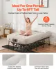 A woman sits on an inflatable bed with a metal frame. Podgląd zdjęcia produktu