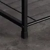 Close-up of the black metal leg and wire shelf of a shoe rack. Náhled obrázku produktu