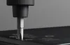 A close-up shot of a screwdriver bit being inserted into a screw on a black surface. Náhled obrázku produktu