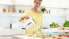 A woman is pouring hot water from a white electric kettle into two glasses with mint and lime. Produktbild-Vorschau