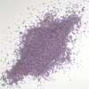 A pile of small, purple, rod-shaped sprinkles scattered on a white surface. Voir les images du produit