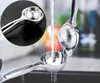 A close-up shot of a metal citrus juicer being rinsed under running water, with a magnified inset showing the juicer's bowl. Produktbild-Vorschau