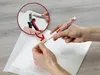 Hands using a marker and pliers on a paper towel. Produktbild-Vorschau