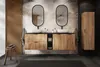 A modern bathroom vanity with two sinks, mirrors, and wooden cabinets, set against a tropical-themed wallpaper. Anteprima dell’immagine prodotto