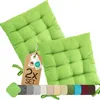 Two green seat cushions are displayed against a white background, with a tag and a row of color swatches below. Produktbild-Vorschau