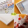 A collage of images showing a paint-by-numbers kit for adults, including paints, brushes, canvas, and hardware. Produktbild-Vorschau