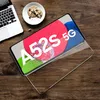 A Samsung Galaxy A52s 5G phone with a screen protector on a wooden table next to a laptop and cookies. Produktbild-Vorschau