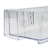 A close-up view of a clear plastic refrigerator door shelf. Náhľad obrázku produktu