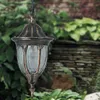 A hanging outdoor lantern in a garden setting. Náhled obrázku produktu