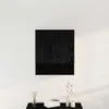 A black wooden cabinet mounted on a white wall, with decorative items on a black surface below. Voir les images du produit
