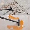 A split image showing a vacuum cleaner head cleaning dry debris on a tiled floor and then cleaning a liquid spill on a tiled floor. Produktbild-Vorschau