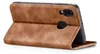 A brown leather flip case for a smartphone is shown from a side angle, with the front cover open. Produktbild-Vorschau
