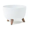 A white planter with a ribbed texture and three brown legs, isolated on a white background. Náhľad obrázku produktu