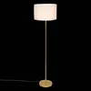 A floor lamp with a gold base and stem, and a white textured lampshade, isolated on a black background. Anteprima dell’immagine prodotto
