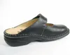 A black leather clog shoe is shown from the side against a white background. Podgląd zdjęcia produktu