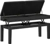 A black piano bench with its lid open, revealing storage space inside. The bench is elevated on a metal frame with adjustable height mechanisms. Podgląd zdjęcia produktu